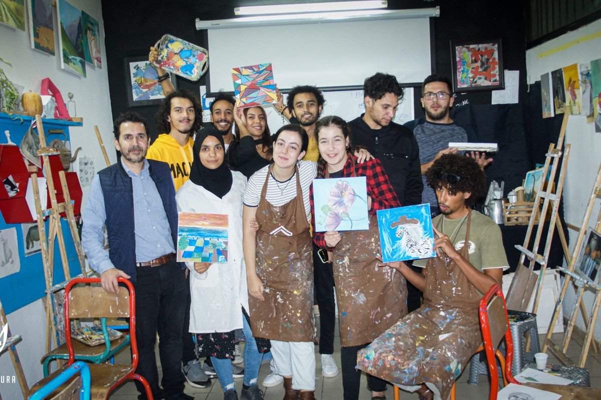 Young people painting at easels during a Discovery Workshop session