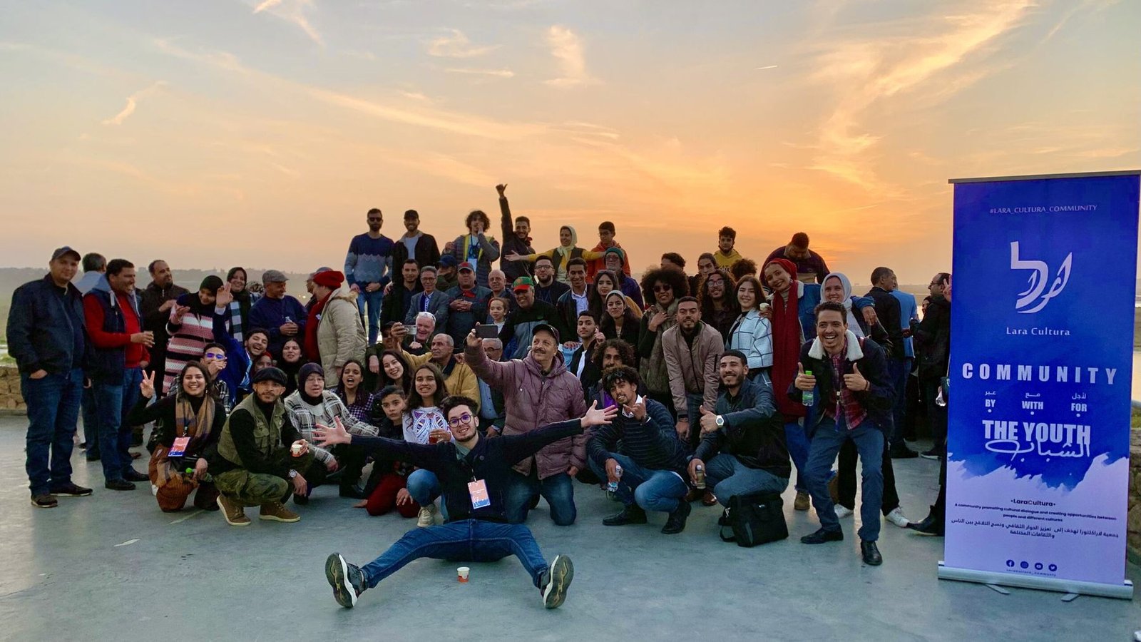 Participants of a LaraCultura activity gathered together at sunset