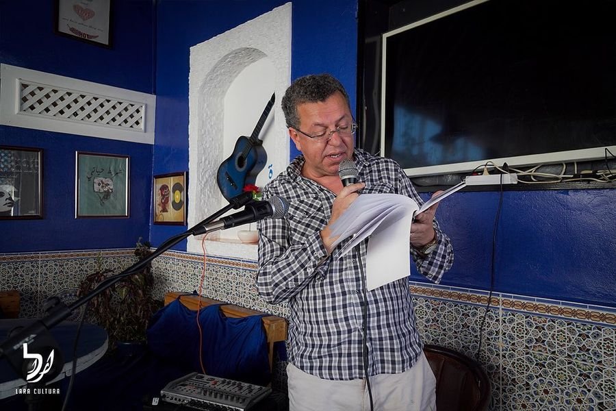 A performer reading at an OpenMicultura evening